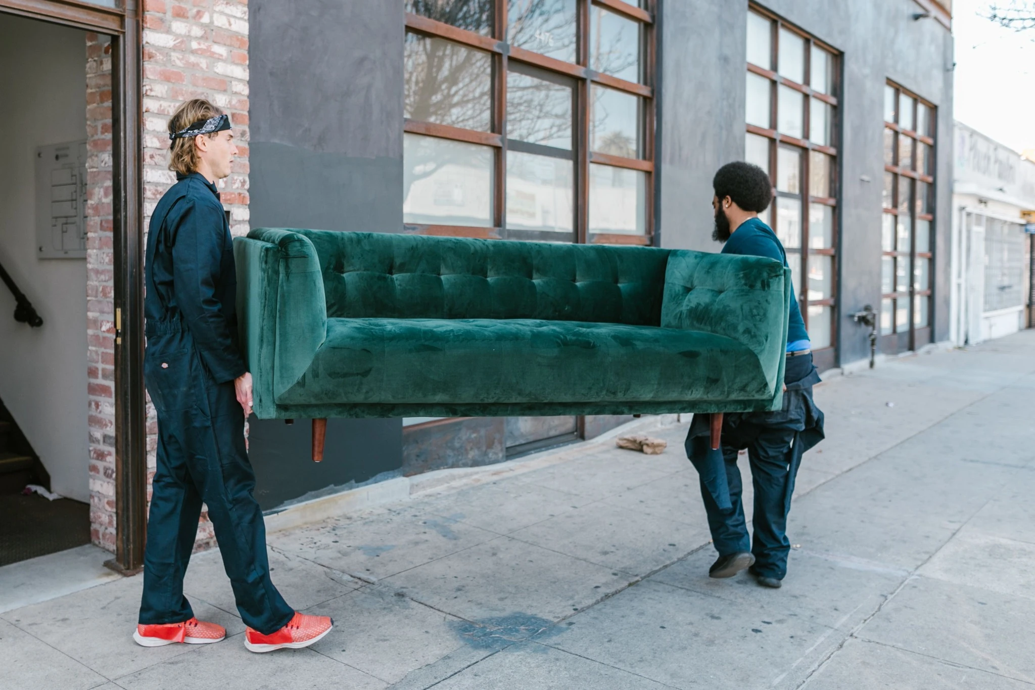 Rowshan moving crew handling household furniture during a residential move